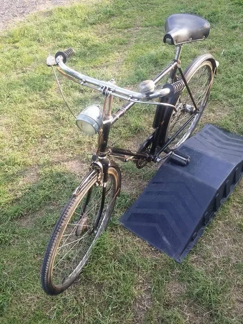 The black Raleigh from the front, with a chrome headlamp and black grips