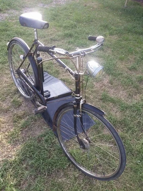 The black Raleigh from the front three-quarter, with a chrome headlamp