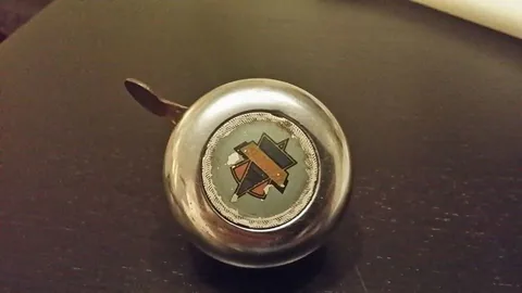 Chrome bell with a coloured badge on the top
