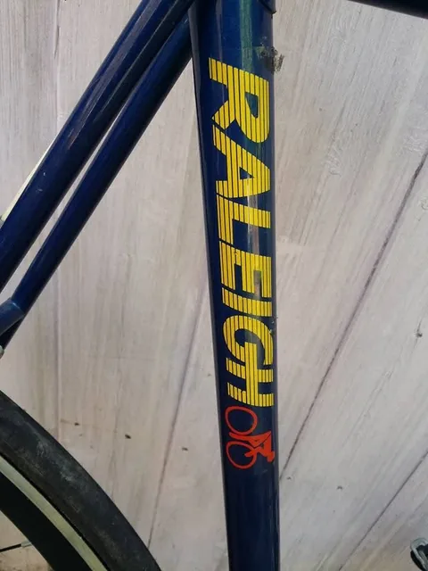 Seat tube with RALEIGH in yellow and a red cyclist logo