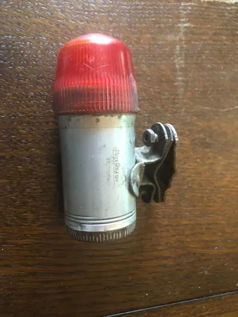 Silver rear lamp with a red ribbed lens and a frame clip