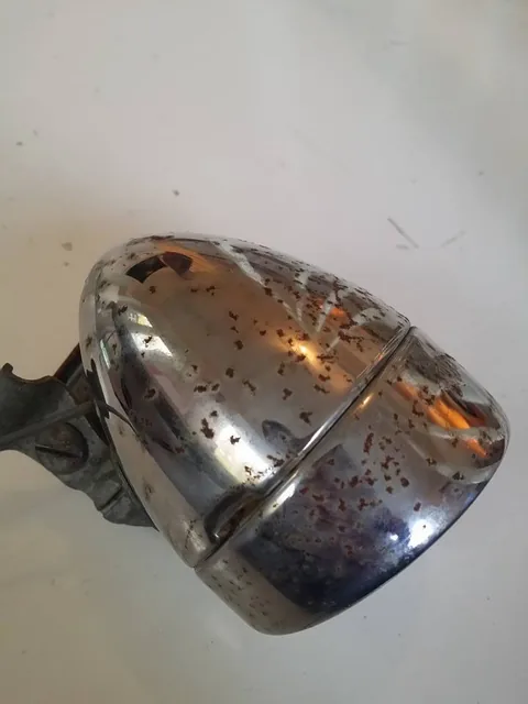 Chrome front lamp with rust spots across the shell