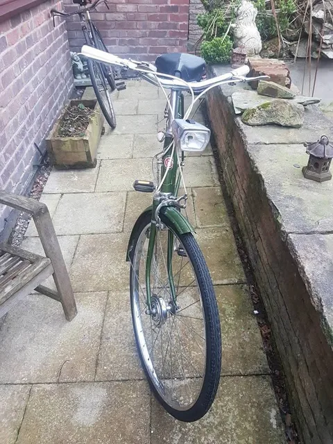 Front view of the green Hercules with a square headlamp and cream cables