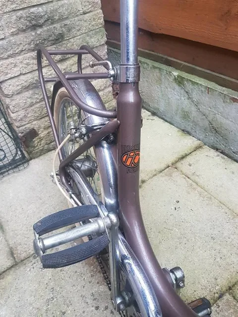 Seat tube decal with an orange HC monogram on a brown frame