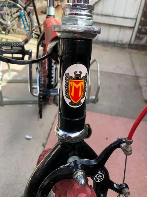 Head tube transfer showing a red and yellow M shield