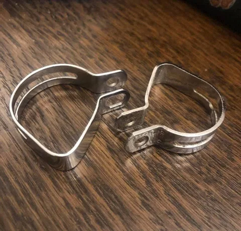 Two polished band clamps with slotted bands
