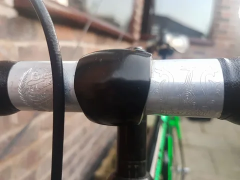 Handlebar sleeves engraved Alloy, Raleigh, Made in England on one side and the Raleigh heron on the other