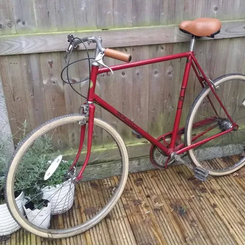 Red Hercules gents' bicycle with cream tyres, brown grips and a brown saddle
