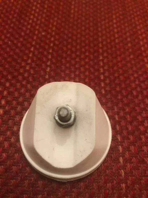 Back of the white reflector housing, with its fixing bolt