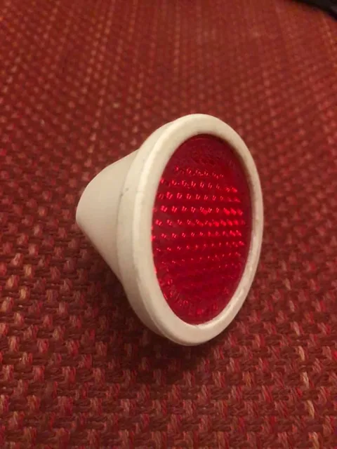 Round red reflector in a white housing