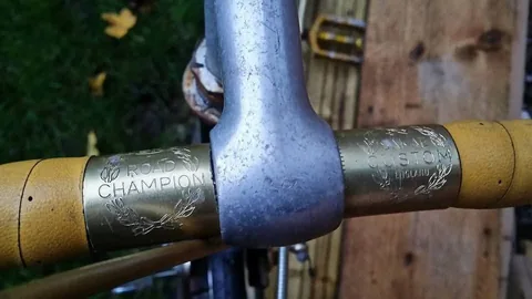 Handlebar centre sleeves engraved Road Champion and Custom England, with yellow bar tape