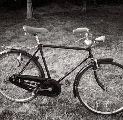 Black and white photo of a Forever gents' roadster with a full chaincase, a rear carrier and a headlamp