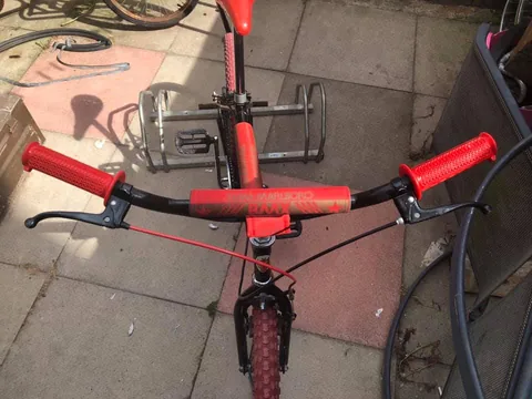 BMX handlebars with red grips and a Team Marlboro BMX pad