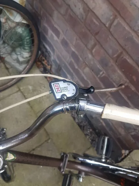 Sturmey-Archer gear trigger on a chrome handlebar, marked Sturmey Archer England, with gear positions